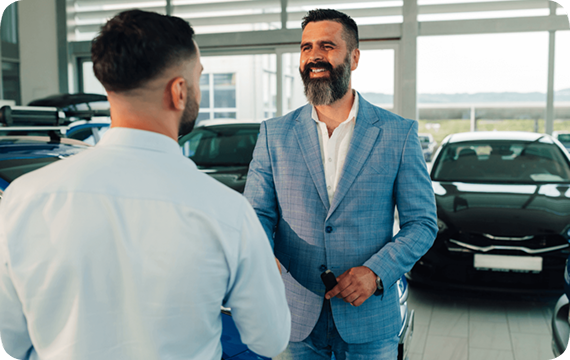 man in blue shirt shakes hand with customer
